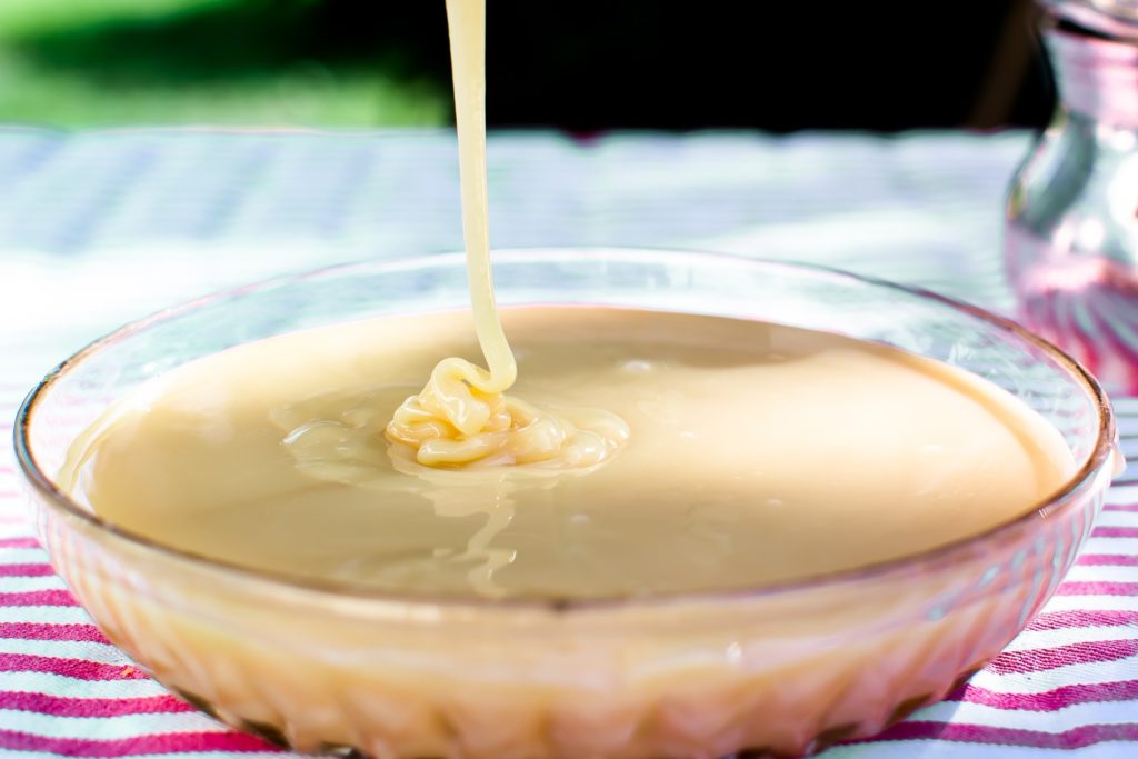 sweetened condensed milk in a clear bowl 