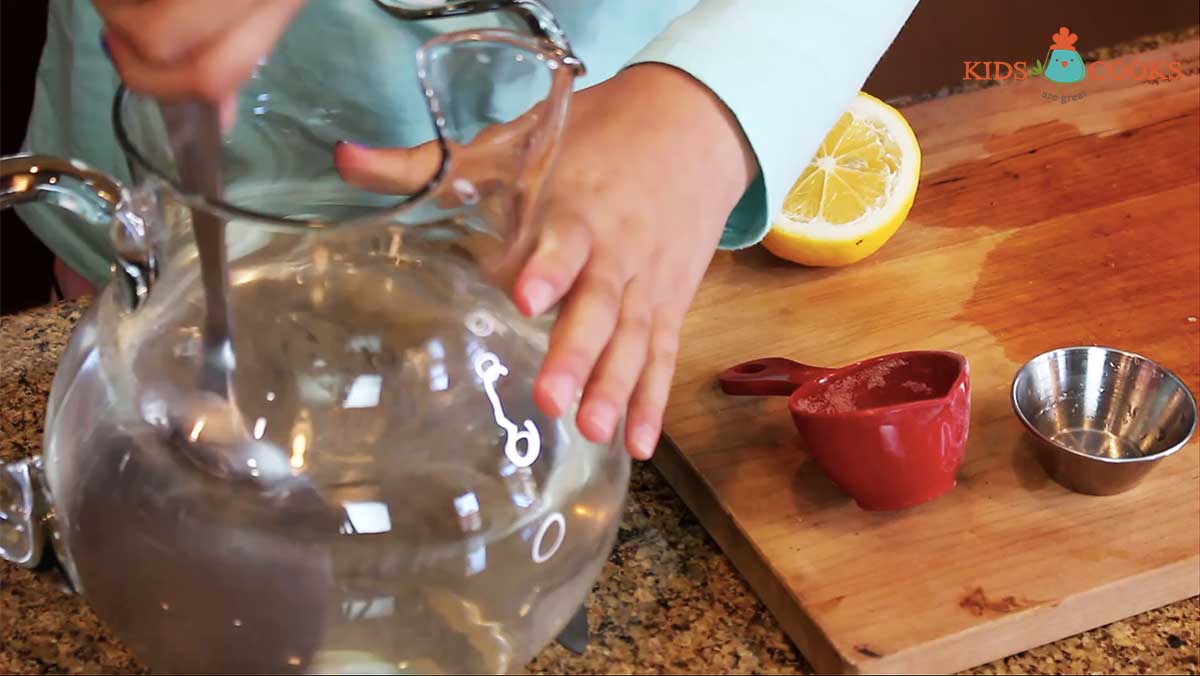 Add-sugar-and-lemon-into--a-pitcher-of-water