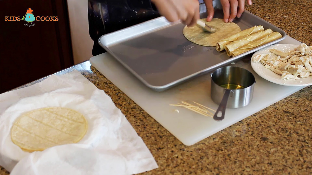 Brush the tortillas with olive oil, fill them with chicken, and roll them up