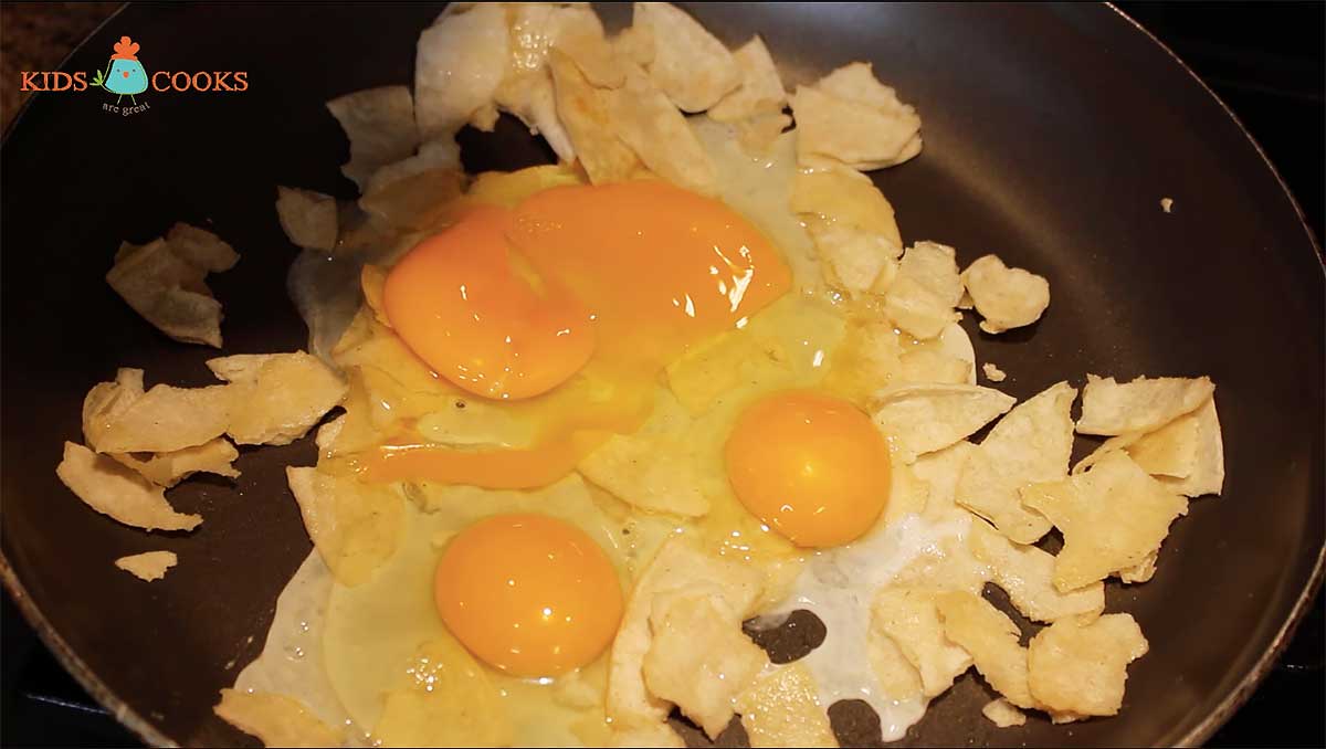 Crack two eggs into the pan and scramble