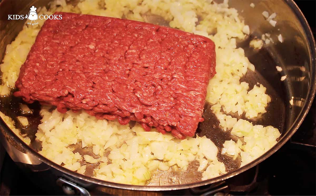 add olive oil, chopped onion and ground beef into a pan